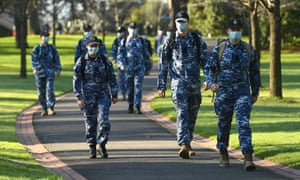 Members of the Australian Defence Force walk through Fitzroy Gardens.
