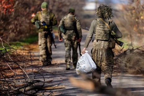 Ukrainian soldiers move along a street in the Kherson region.