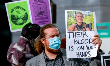 A protester holds a photograph of environmental activist Manuel Esteban Paez Terán outside Atlanta City Hall on 31 January.