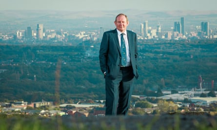 Holmes, poses for a photograph above Bolton with the skyscrapers of Manchester city centre in the background.