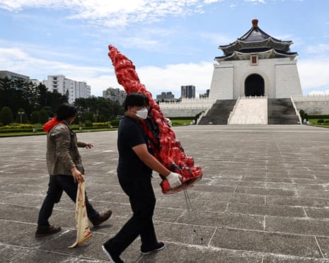 Staff take down “Pillar of Shame” that was defaced with black paint in front of Chiang Kai-shek Memorial Hall, in Taipei, Taiwan in 2022.