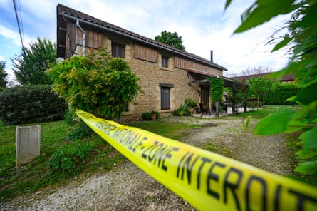 Yellow police tape seals off a detached property