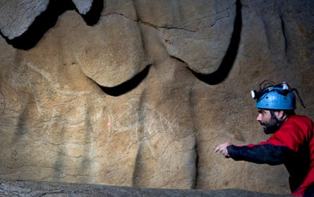 Garate uses a laser pointer to reveal paintings of horses in the Atxurra cave in the Basque village of Berriatua.