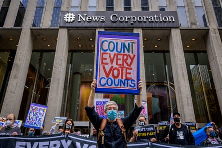 A demonstrator holds a ‘Count every vote’ sign outside Fox News in New York, New York, on 22 October.