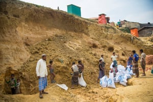 Refugees fill sandbags, as the camps prepare for the monsoon season.