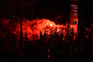 Fans light flares as they celebrate Liverpool winning their first league title in 30 years.