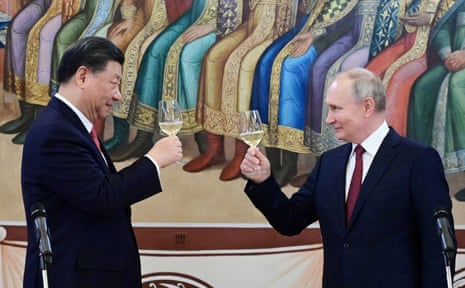 Russian President Vladimir Putin and Chinese President Xi Jinping attend a reception at the Kremlin on Tuesday.