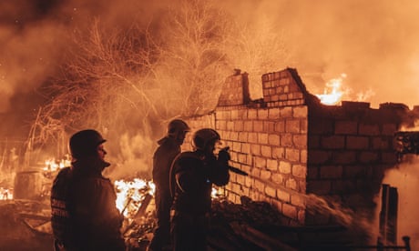 Emergency service workers extinguish a fire after shelling on the Bakhmut frontline in Ivanivske, Ukraine.
