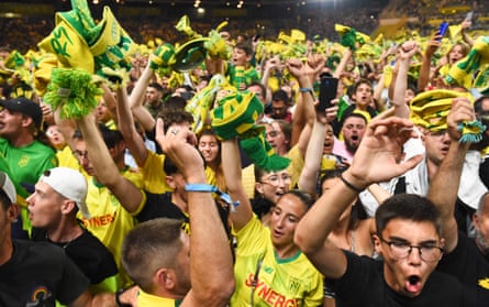 Nantes fans celebrate after their team beats Angers and stays in Ligue 1.