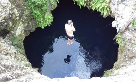 Man jumping into one of the Siete Bocas