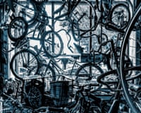 Black and white and blue image of a bicycle shop window, with lots of bikes hanging in it