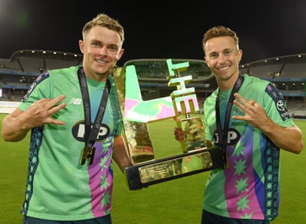 Sam Curran lifts the Hundred trophy with Tom Curran.