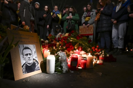 People lay flowers and light candles in front of the Russian embassy in Berlin, Germany.