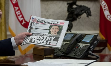A copy of the New York Post is held up in the Oval Office in May 2020. 