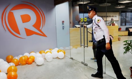 A guard opens a door at the office of Rappler in Pasig, Metro Manila, Philippines.