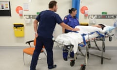 Ambulance and medical staff attend to a patient at St Vincent’s hospital emergency department, Sydney.