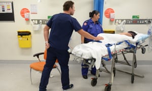Ambulance and medical staff attend to a patient at St Vincent’s Hospital in Sydney.
