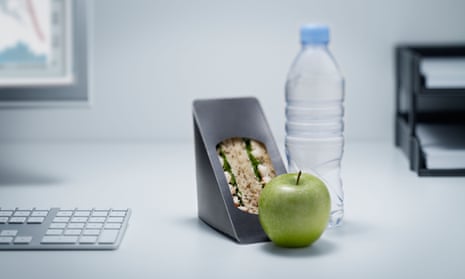 A sandwich and drink at an office desk