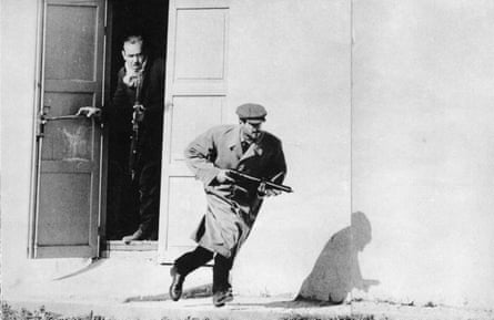 A Turk sprints from the exposed doorway of an old cinema in Limassol, Cyprus. Used in Observer 16/2/64