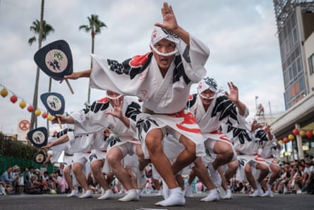 Eiji Ohmatsudani of the Sasa-ren leading dancers on a street during the Awa Odori festival in Tokushima on 13 August. The four-day festival attracts more than 1.2 million people annually