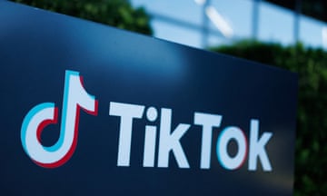 Outdoors view of white TikTok logo on a company sign.