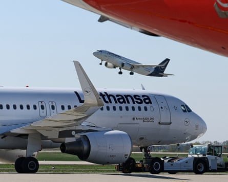 Lufthansa plane on a runway and one taking off