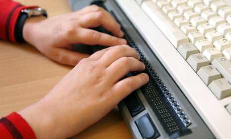 A computer user types on a Braille keyboard. US law insists websites should be accessible to people with disabilities.