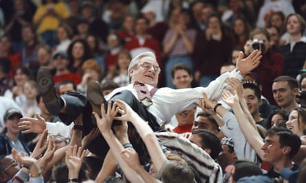 Rev. Jerry Falwell crowd surfs held by students in 1997 during the Big South Tournament semifinal basketball game at Liberty University.