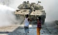 Palestinian children throwing stones at an Israeli tank in the West Bank in 2003.