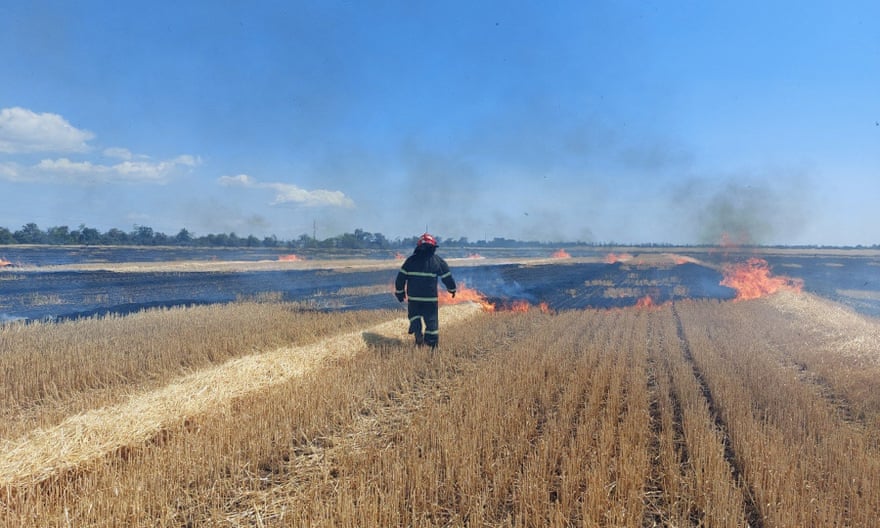 A firefighter works in a burning field near Mykolaiv.