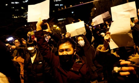 People hold white sheets of paper during a protests against Covid restrictions in Beijing in November last year