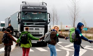 Activists block the road outside an Amazon centre in Bretigny-sur-Orge
