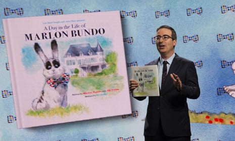 John Oliver holds the book A Day in the Life of Marlon Bundo on his HBO show in 2018.