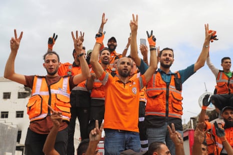 Palestinian emergency personnel celebrate in Gaza City, after US president Donald Trump announced that Israel and Hamas had agreed on the first phase of a Gaza ceasefire.