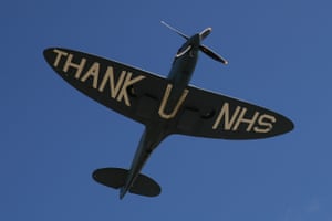 A spitfire plane performs a fly past in support of the NHS.