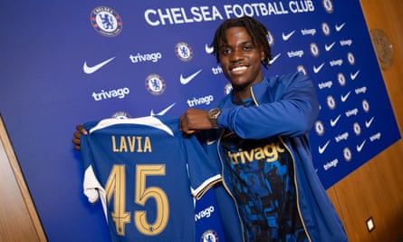 Roméo Lavia holding up his No 45 Chelsea shirt