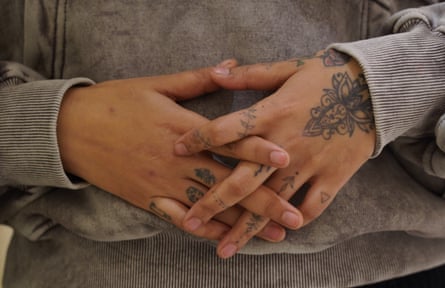 Chhetri’s tattooed hands rest together in front of her stomach.
