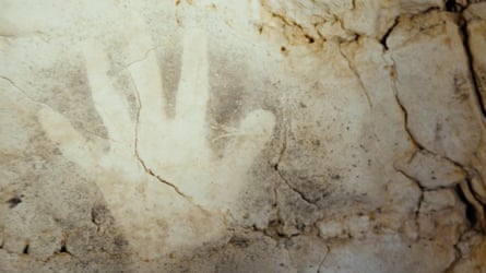 Across millennia … a cave-painting handprint in the film.