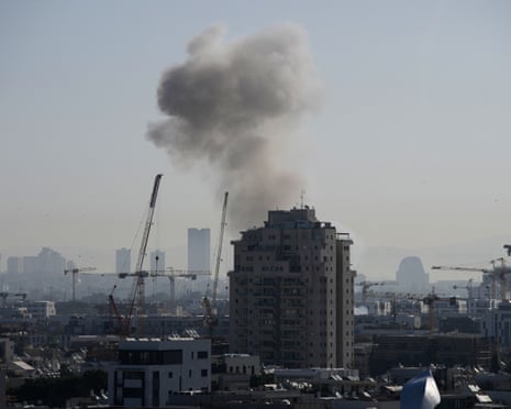 Smoke billows in Tel Aviv after the strikes, which reportedly injured at least six people