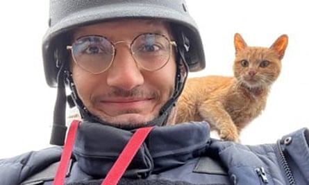 AFP journalist Arman Soldin with a cat on his shoulder