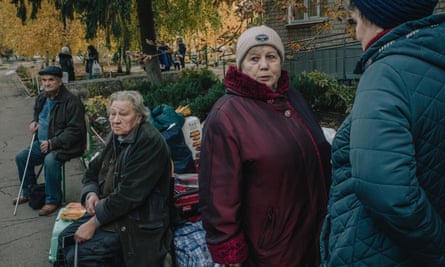 Evacuees from Kupiansk and surrounding villages wait outside a reception centre in Kharkiv.