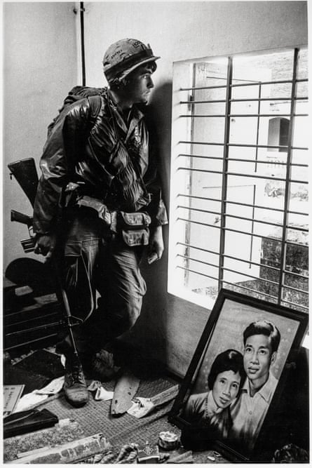 A soldier looking out of a window.