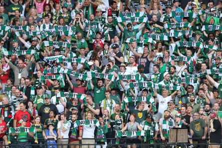 Portland Timbers fans hold up scarves during a match at Providence Park.