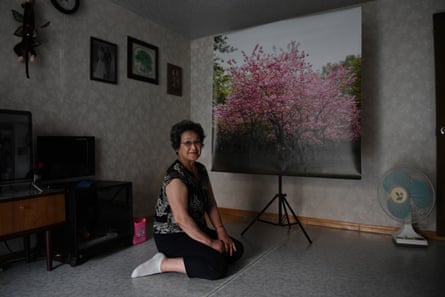 Mitsuko Minakawa looks at a photograph of the cherry blossoms in Maruyama park which she lived near and often visited as a child. She moved to North Korea in April 1960 with her Korean husband and has been living there ever since.