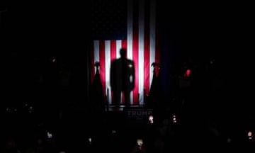 Silhouette of man in front of American flag
