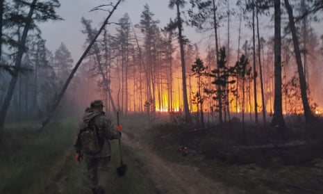 A volunteer heads to douse a forest fire in the republic of Sakha also known as Yakutia, in Russia’s far east.