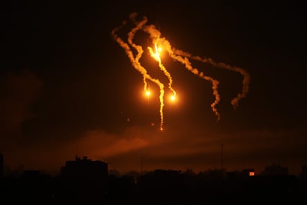 A lighting flare fired by Israel forces in the sky above north-west Gaza on 31 October 2023.