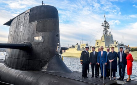 Emmanuel Macron (second left) and Australian Prime Minister Malcolm Turnbull (C) stand on the deck of HMAS Waller, a Collins-class submarine operated by the Royal Australian Navy, at Garden Island in Sydney in May 2018.