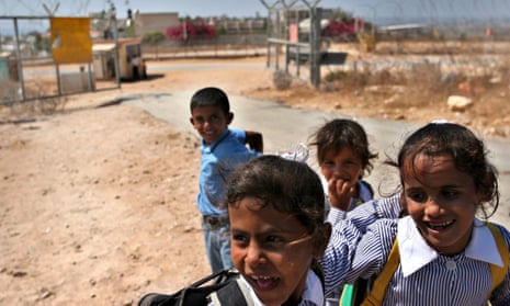 Palestinian school children on the Ras al-Tirah side of the Israeli military checkpont that separates this area from neighbouring Ras Atiyah, where their school is.