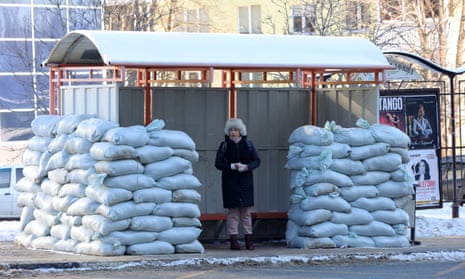 A woman waits at a bus stop protected with sandbags following recent Ukrainian shelling attacks in Belgorod, Russia.
